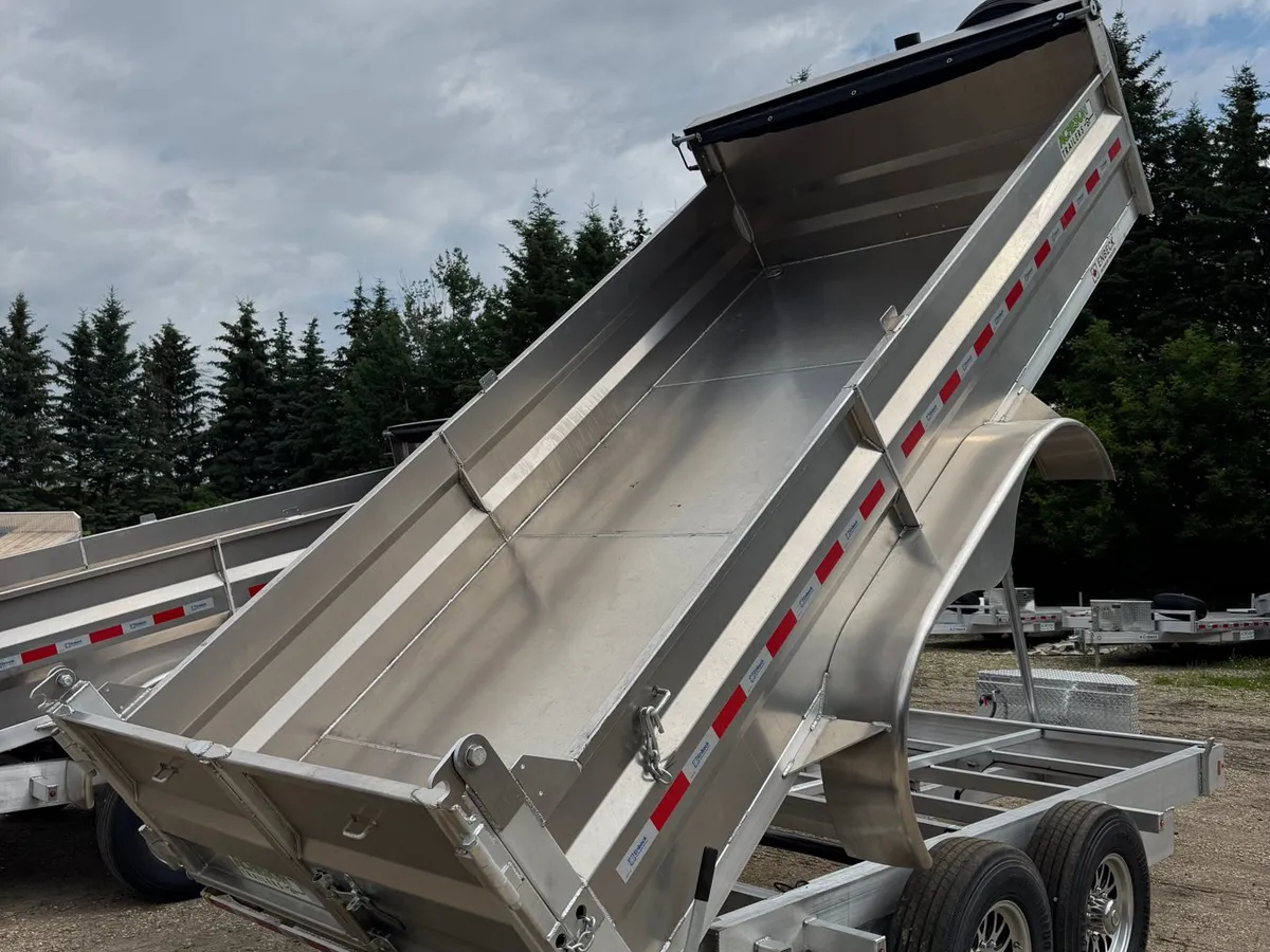 Enbeck 7 by 14 aluminum heavy duty dump trailer with the box raised on the Acheson Trailers lot
