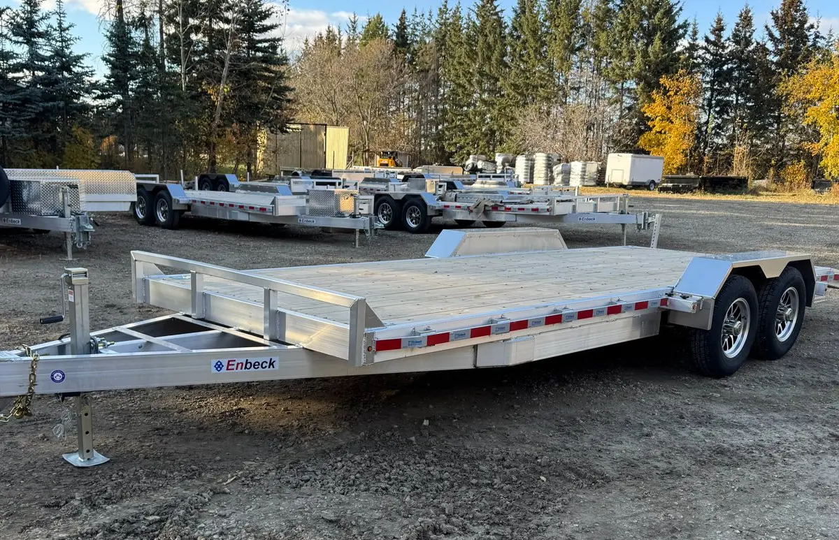 Enbeck aluminum tilt deckover trailer with the deck tilted, parked on the Acheson lot
